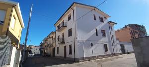 a white building on the side of a street at Tranquillità e comodità a due passi dal centro in Tortolì