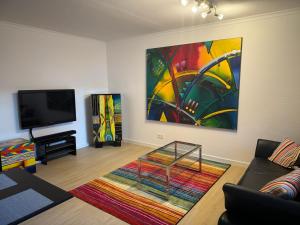 a living room with a large painting on the wall at Ferienwohnung Kity mit Terrasse und Bergblick in Grainau