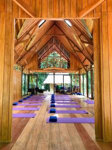 a large room with purple yoga mats on the floor at Casa Amazonas in Puerto Maldonado