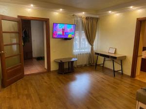 a living room with a flat screen tv on the wall at Apartment on Kostyushka 20 in Lviv