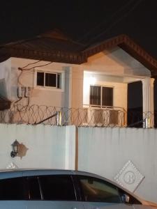 a car parked in front of a house at Treasure Apartment in Lagos