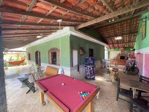 a room with a pool table in a house at Sun House WSL in Saquarema