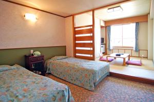 A bed or beds in a room at Diamond Shiga