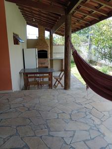 a hammock on the patio of a house at Tropical Paradise in Ubatuba
