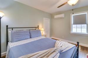 a bedroom with a blue bed and a window at Orange Cottage with Hiking Access 1 Mi to Lake Anna in Kirk O'Cliff