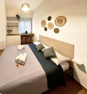 a bedroom with a large bed with towels on it at SAINT GEORGE'S HOUSE 4 Bari in Bari