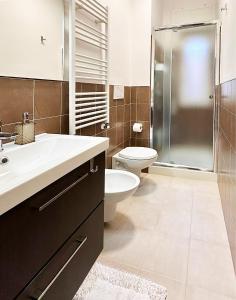 a bathroom with a sink and a toilet and a shower at SAINT GEORGE'S HOUSE 4 Bari in Bari
