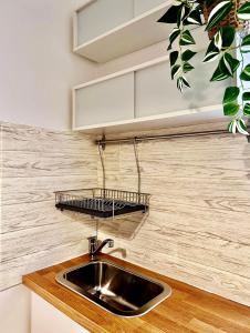 a kitchen with a sink and a shelf above it at SAINT GEORGE'S HOUSE 4 Bari in Bari