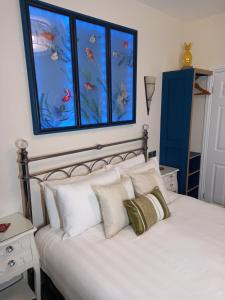 a bedroom with a large bed with white pillows at The Gatsby Blackpool - Formerly The Windsor in Blackpool