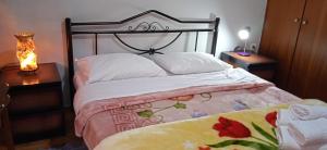 a bedroom with a bed and a lamp on a table at STEVE'S HOUSE & ELDI in Edessa
