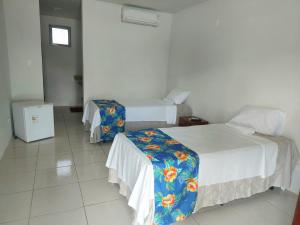 เตียงในห้องที่ Residencial Petur Gravatá