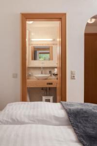 a bathroom with a sink and a mirror at Hotel Kreuz in Pfunds