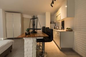 a kitchen with a wooden table in a room at Sweet Dreams Apartment in Tiberias