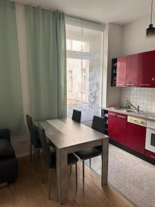 a kitchen with a table and chairs in a kitchen at Stilvolles Zuhause in Magdeburg