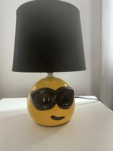 a lamp with a face with sunglasses on it at Stilvolles Zuhause in Magdeburg