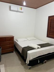 a bedroom with a bed and a dresser at Casa São Miguel dos Milagres in São Miguel dos Milagres +34 photos