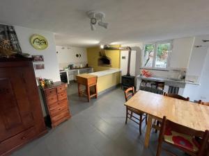 a kitchen with a table and a dining room at Casa in campagna: Completo Relax in Albissola Marina +11 photos
