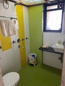 a bathroom with a toilet and a sink at Calm Private Room with Beautiful View in Mumbai