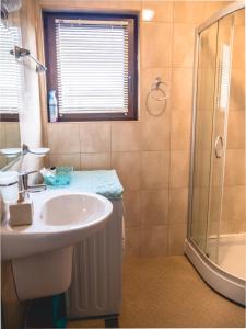 a bathroom with a sink and a shower at Apartment 7 and Studio 2 Quietly and peaceful place to relax in Sozopol