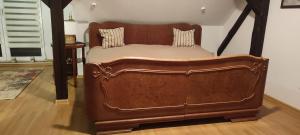 a large wooden bed in a room with at LAZARÓWKA - RYBNO in Rybno +48 photos