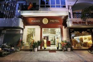 a store front of a hanoi hotel with people standing outside at Hanoi Chic Boutique Hotel in Hanoi