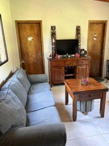 a living room with a couch and a coffee table at Cabaña “La Herencia” Paraguarí in Paraguarí