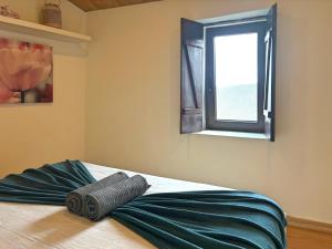 a bed in a room with a window at Retiro de Gondramaz - All house 200 m2 in Gondramaz