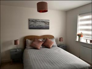 a bedroom with a bed with two night stands and two lamps at Double Room in a Family Home - 15 Minutes Walk to Famous Bicester Village in Chesterton