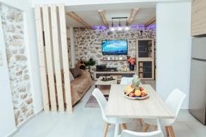 a living room with a table and chairs at luxury house in Ierápetra