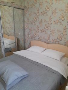a bedroom with a large bed with a mirror at Cathedral Park Medium Apartment in Chişinău +7 photos