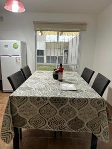 a dining room table with a table cloth on it at Duplex 2 Dormitorios Neuquén in Neuquén