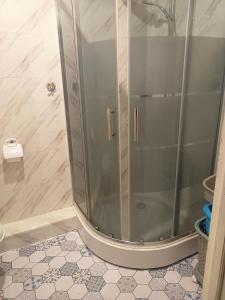 a shower with a glass door in a bathroom at Kołobrzeg-hotel Polonia apartament 207 in Kołobrzeg