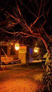 a couple of chandeliers hanging from a house at night at Res. Orion Praia do Espelho in Praia do Espelho