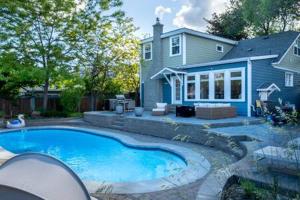 a large swimming pool in front of a house at The Corner Cottage Pool Oasis in Penticton