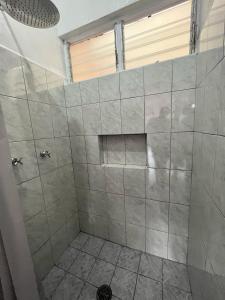 a bathroom with a shower with gray tiles at La Casita in Pátzcuaro