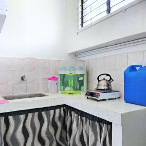 a kitchen with a tea kettle on a counter at RM3 - Ground Floor Unit in San Roque Bauan Batangas in Batangas City