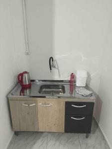 a kitchen with a sink and a counter top at Studio novo 2024 próx. Aeroporto in Passo Fundo