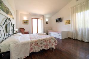 a bedroom with a large bed and a window at Villa Ray in Capoliveri