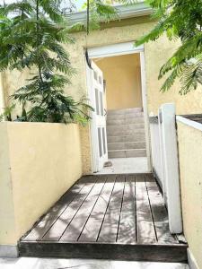 an open door to a house with a porch at Studio Cosi Sxm in Marigot