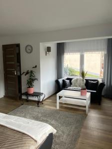 a living room with a couch and a table at Pension mit Moselblick in Klotten