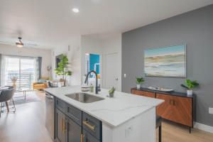 a kitchen with a sink and a living room at Minutes from Kierland King Bed Lux Pool with View S433 in Scottsdale