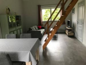 a living room with a couch and a table at Chalet am Weiher in Recht