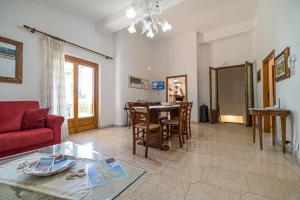 a living room with a red couch and a table at Villa Ray in Capoliveri