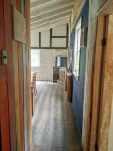 a hallway of a house with blue walls at Cabaña en el bosque de Chiloé in Quemchi