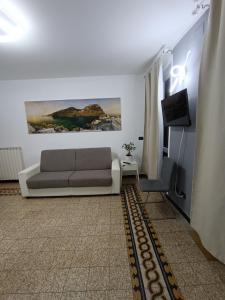 a living room with a couch and a television at Ines Apartment in Manarola