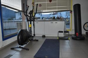 a fitness room with a gym with a treadmill at La cadole de Clem in Juliénas