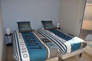 a bed with two pillows on top of it at La cadole de Clem in Juliénas