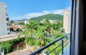 a view of a palm tree from a balcony at Caseros Suite!! Hermoso Apart en Corredor turistico de Salta!! in Salta