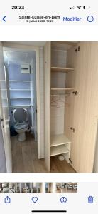 a bathroom with a toilet in a room at Camping Lou PK2 emplacement 15 in Sainte-Eulalie-en-Born