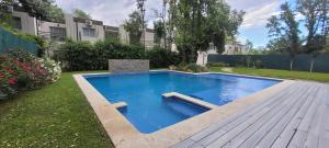 a swimming pool in the backyard of a house at Pilar Norte. Departamentos in La Lonja